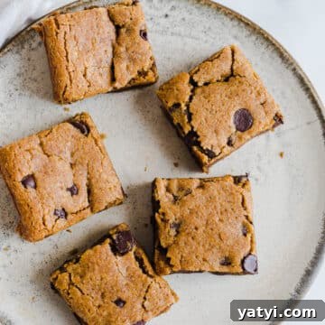 Gluten-Free Pumpkin Chocolate Chip Blondies You’ll Love 13 Blondies with chocolate chips on a plate.