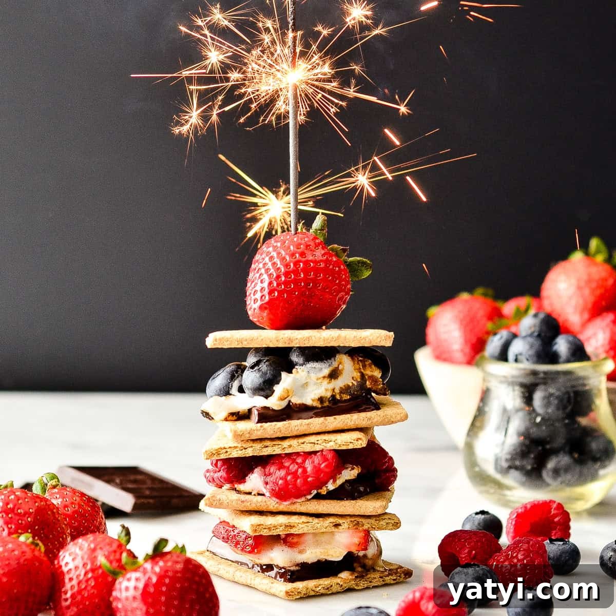 a stack of 3 Berry S'mores with a sparkler on top