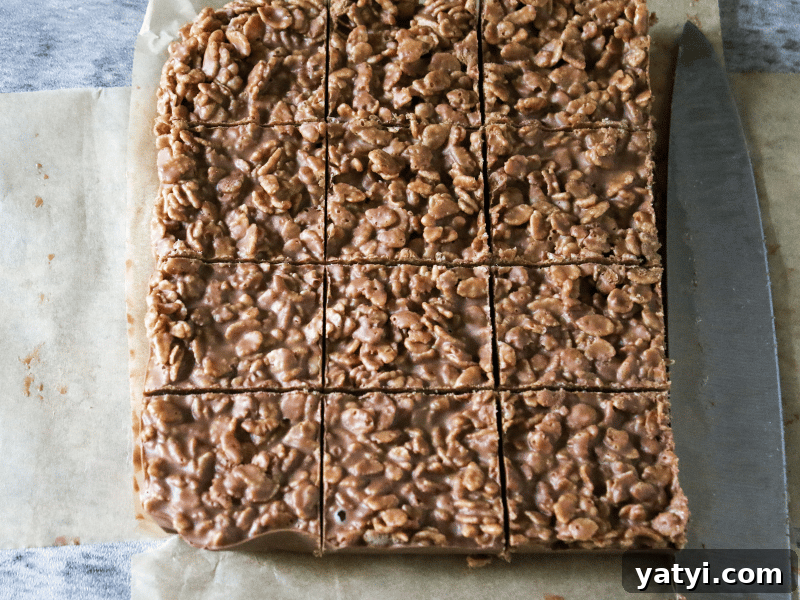 No-Bake Homemade Crunch Bars Recipe for Crispy Chocolate Treats 5 Sliced crunch bars on parchment paper.