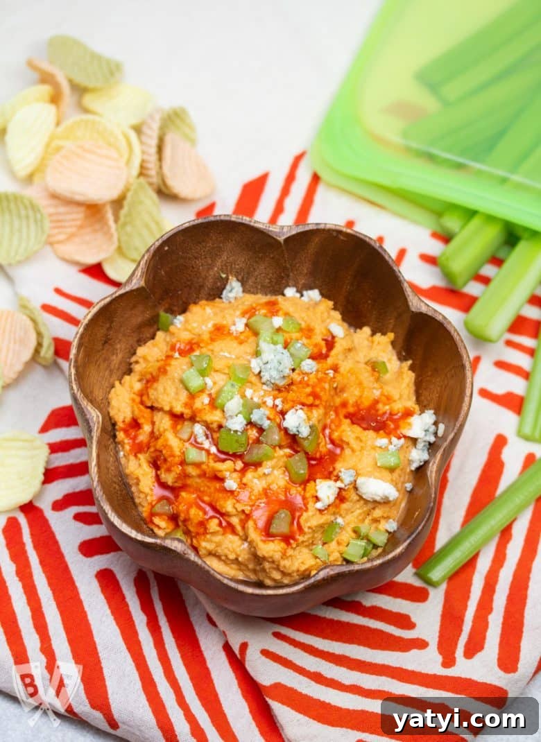 Layered Taco Dip with Refried Beans for Parties and Game Day 15 Bowl of buffalo chickpea dips with veggie chips and celery sticks for dipping