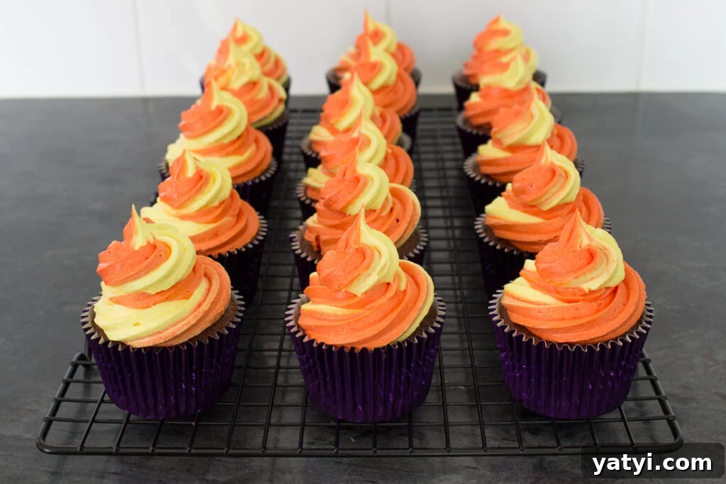 Bonfire Cupcakes Recipe: How to Make Campfire-Style Treats 12 Chocolate cupcakes topped with large swirls of orange and yellow buttercream frosting.