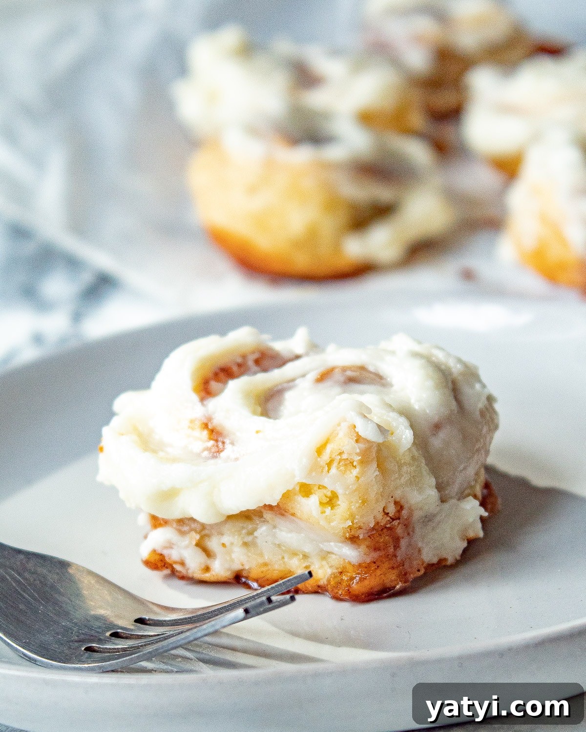 puff pastry cinnamon rolls on a plate with a fork