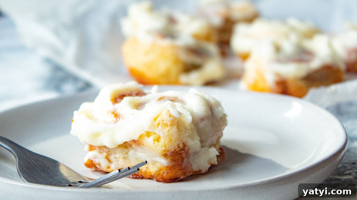 puff pastry cinnamon rolls on a plate with a fork