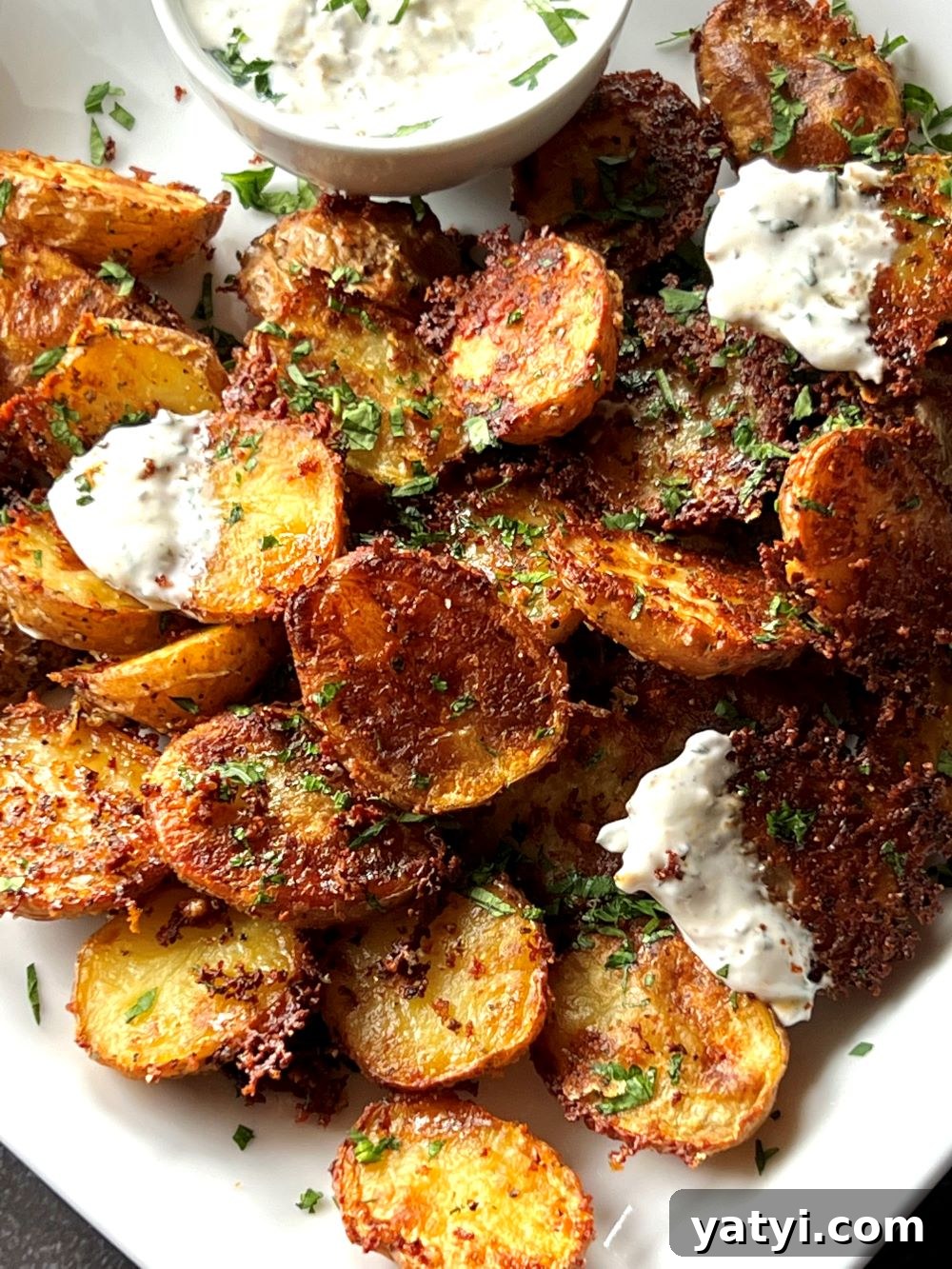 Crispy Parmesan Ranch Roasted Potatoes 4 Crispy potato bites garnished with herbs