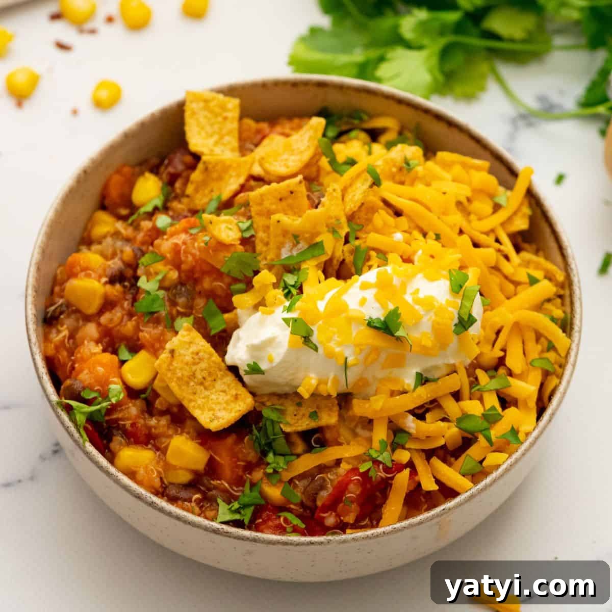 Recipes for Chili Bowl of sweet potato quinoa chili topped with sour cream and corn chips.