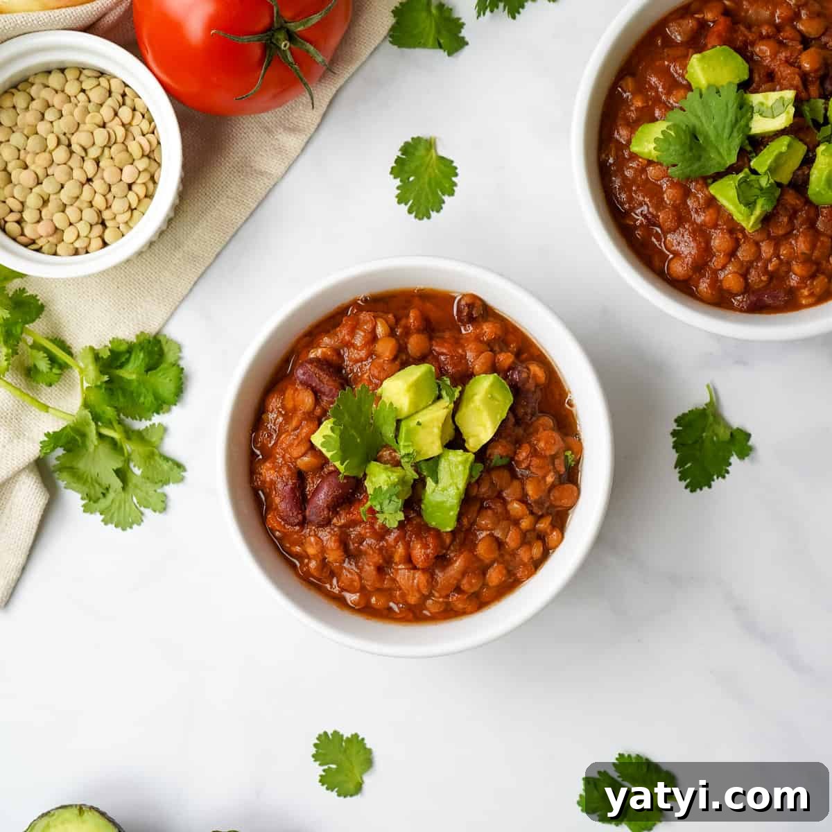 Top Chili Recipes: Flavorful Ideas for Every Occasion 2 Instant Pot Lentil Chili in white bowl topped with diced avocado and cilantro.