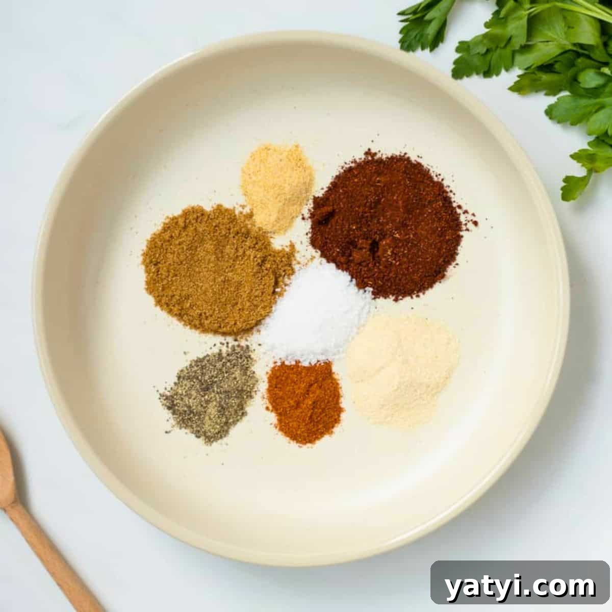 Chili Recipes Spices for chili seasoning in cream bowl made with chili seasoning, onion powder, garlic powder, pepper, cumin, salt, and cayenne.