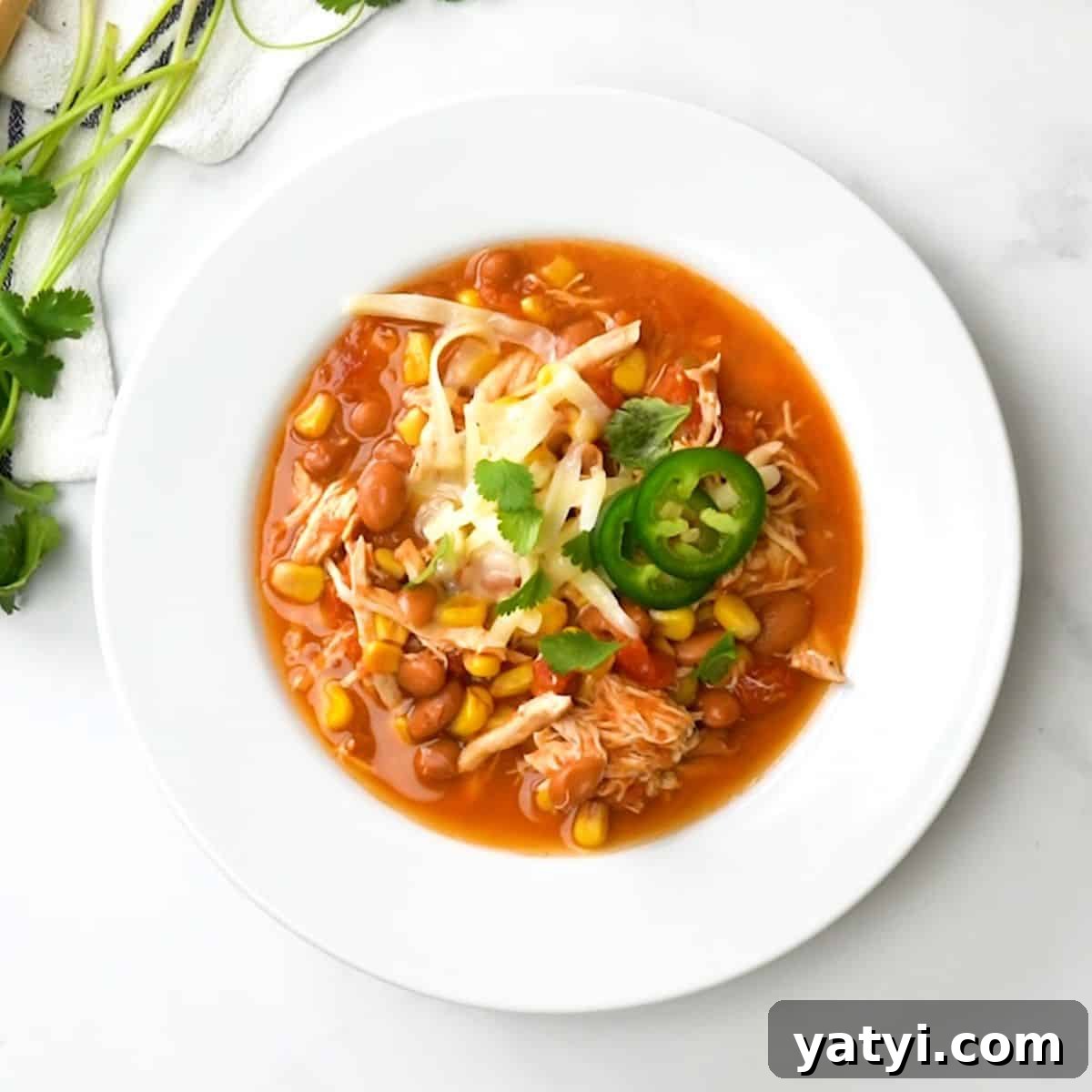 Easy Chili recipes Bowl of instant pot taco chili topped with cheese and jalapenos.