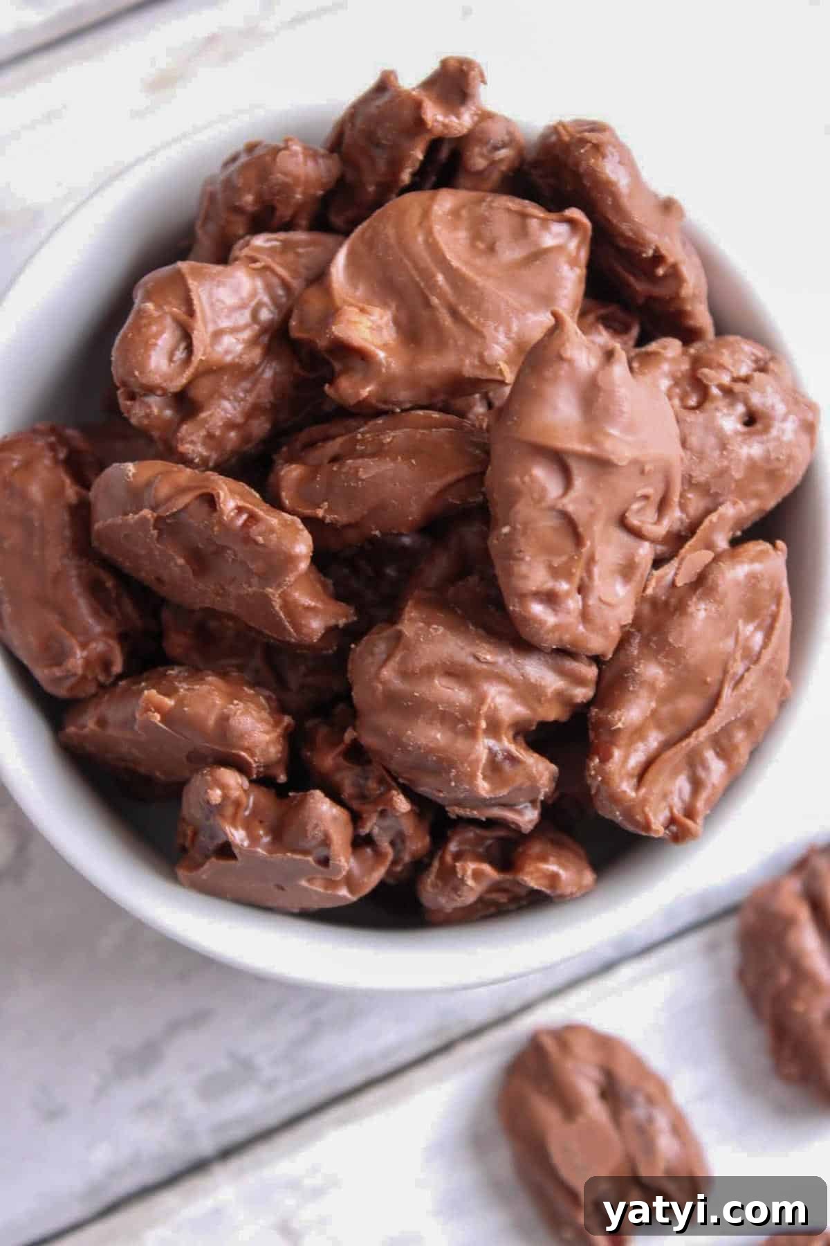 How to Make Chocolate-Covered Pecans at Home 2 Bowl full of chocolate covered pecans.