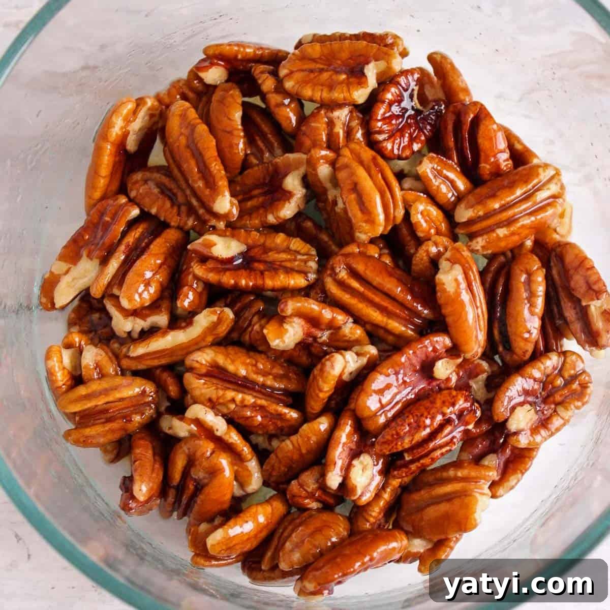 How to Make Chocolate-Covered Pecans at Home 4 Melted butter and pecans mixed together.