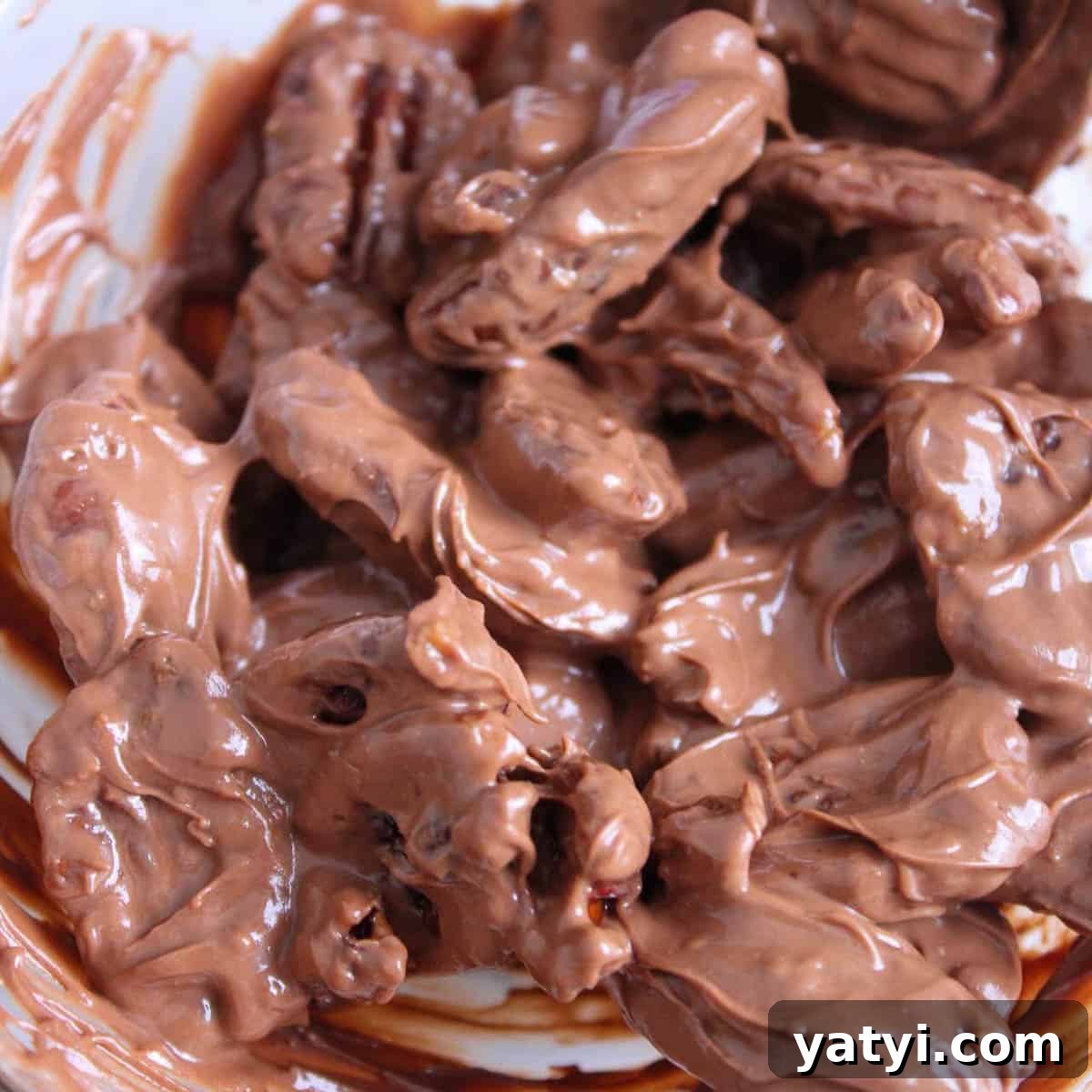 How to Make Chocolate-Covered Pecans at Home 6 Butter Roasted Pecans mixed with melted chocolate and coconut oil.