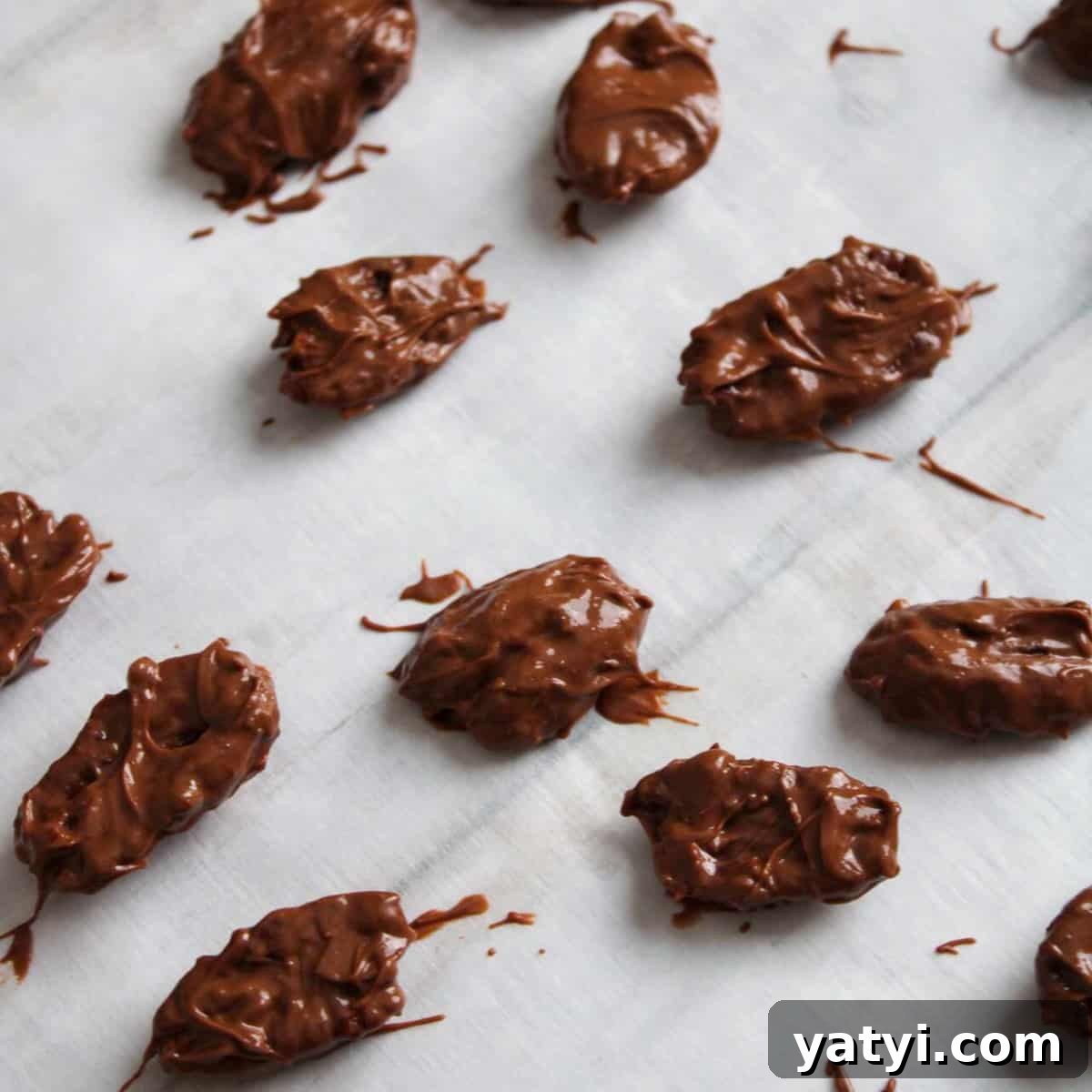 How to Make Chocolate-Covered Pecans at Home 7 Chocolate covered pecans on parchment paper to harden.