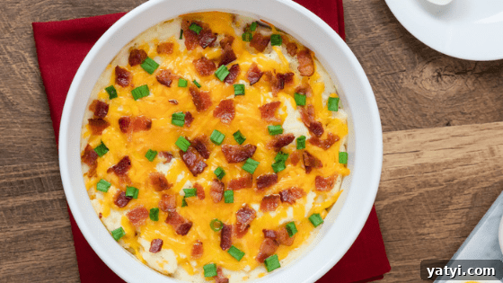 Twice-Baked Loaded Potato Casserole Recipe 2 bacon cream cheese green onion baked potatoes casserole red napkin brown background