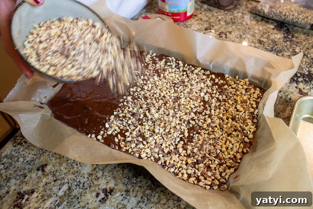 Dark Chocolate Almond Toffee: Crunchy Homemade Recipe 8 chocolate spread in an even layer with almonds