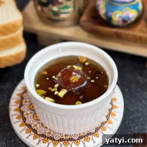 Delicious bread-based gulab jamun soaked in syrup with pistachios and cardamom.