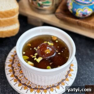 Instant Bread Gulab Jamun Recipe — Soft, No-Yeast Indian Dessert 6 Gulab Jamun served in sugar syrup garnished with chopped pistachios, perfect for traditional Indian.