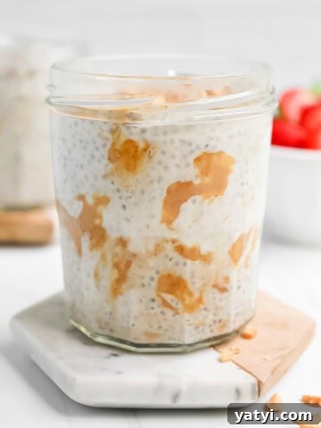 A clear cup filled with chia pudding and peanut butter.