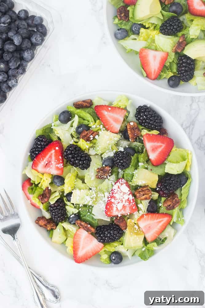 Red, White & Blue Berry Salad with Candied Nuts and Lemon Poppyseed Dressing 4 This red, white, blue summer berry salad is loaded with fresh fruit, topped with avocado slices, feta cheese, & candied nuts, and drizzled with a naturally-sweetened lemon poppyseed dressing