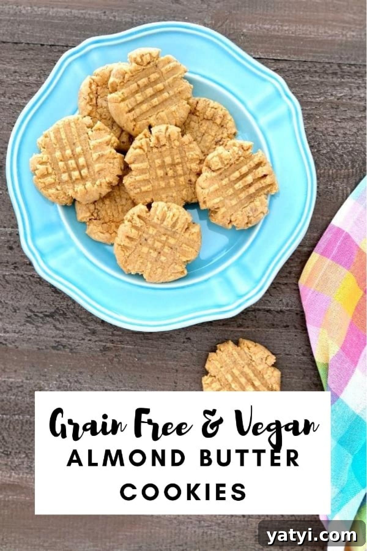Flourless Almond Flour Cookies @spabettie Light blue plate with a pile of almond butter cookies on it, one cookie on the side with a pastel plaid napkin.