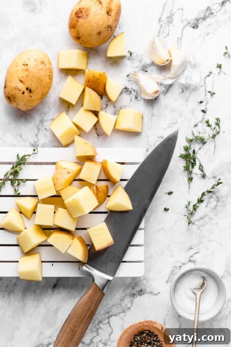 Prep the potatoes. chopped ingredients on a marble board
