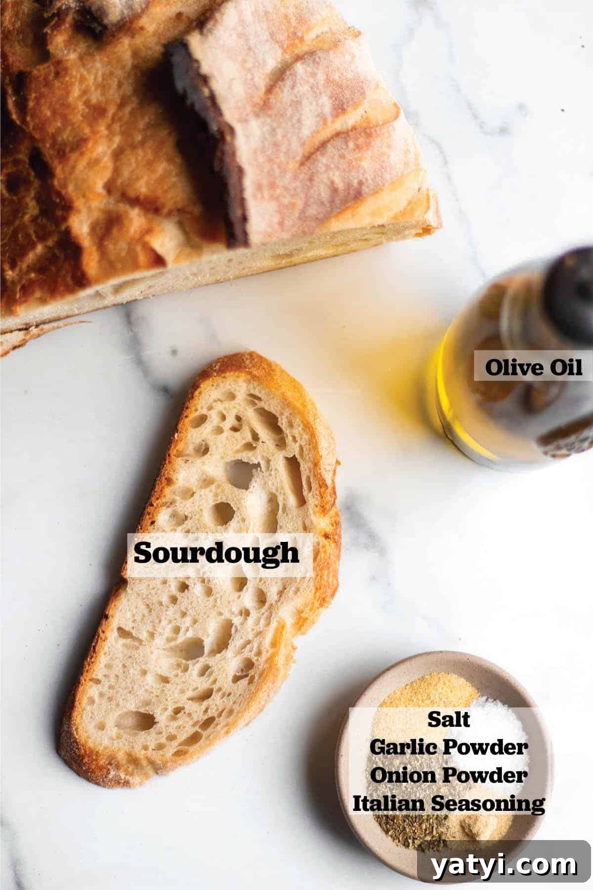 Crispy Sourdough Croutons: How to Make and Store Them Perfectly 3 Half a loaf of sourdough bread with a single slice, bottle of olive oil and a dish with salt, Italian seasoning, garlic powder and onion powder.