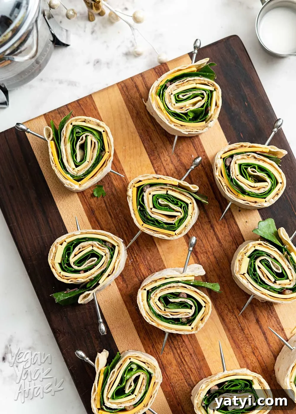 Vegan Holiday Afternoon Tea Menu & Festive Recipes 6 Cutting board with multiple plant-based pinwheels facing up