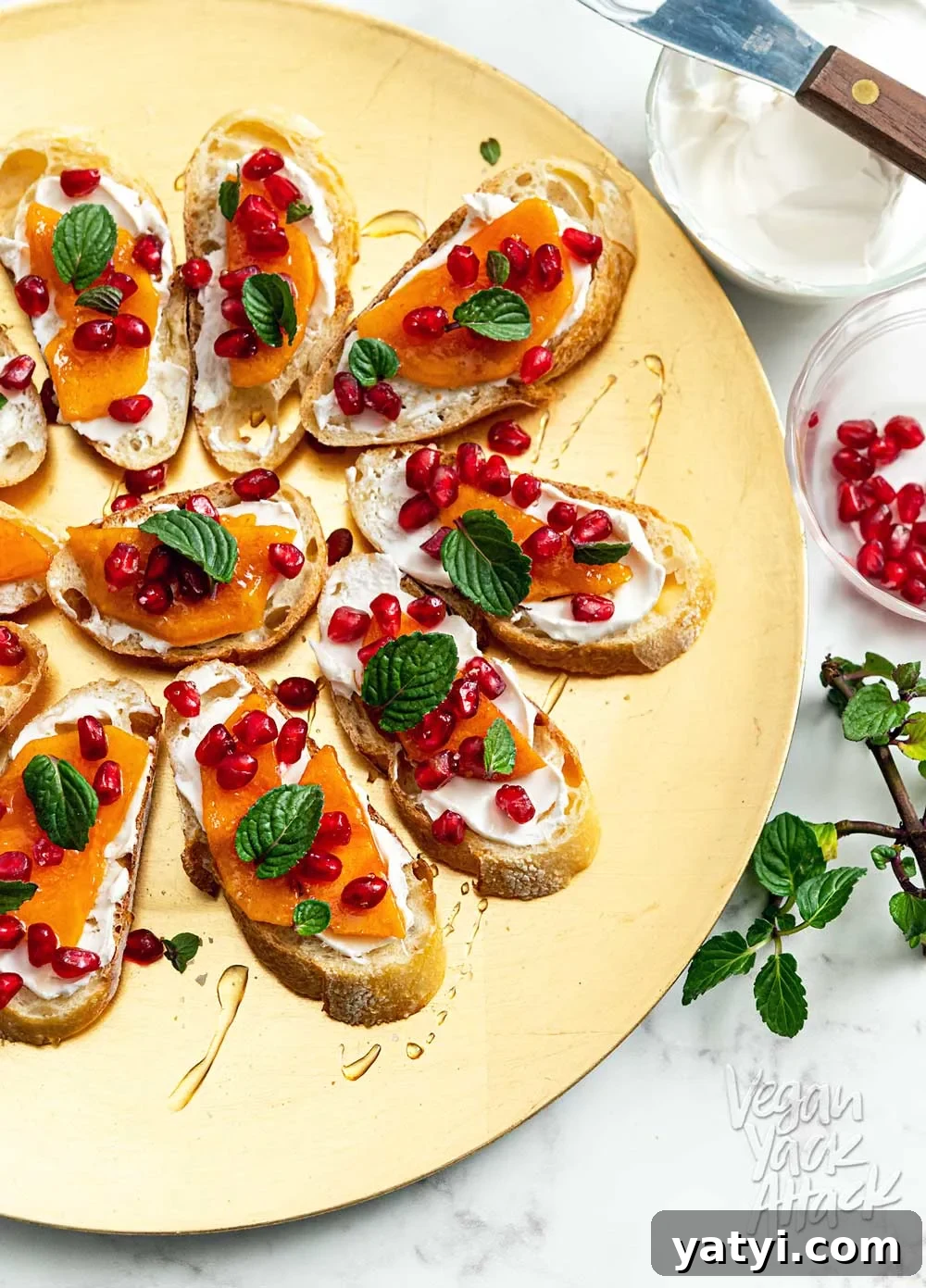 Vegan Holiday Afternoon Tea Menu & Festive Recipes 12 Gold plate topped with pomegranate persimmon crostini