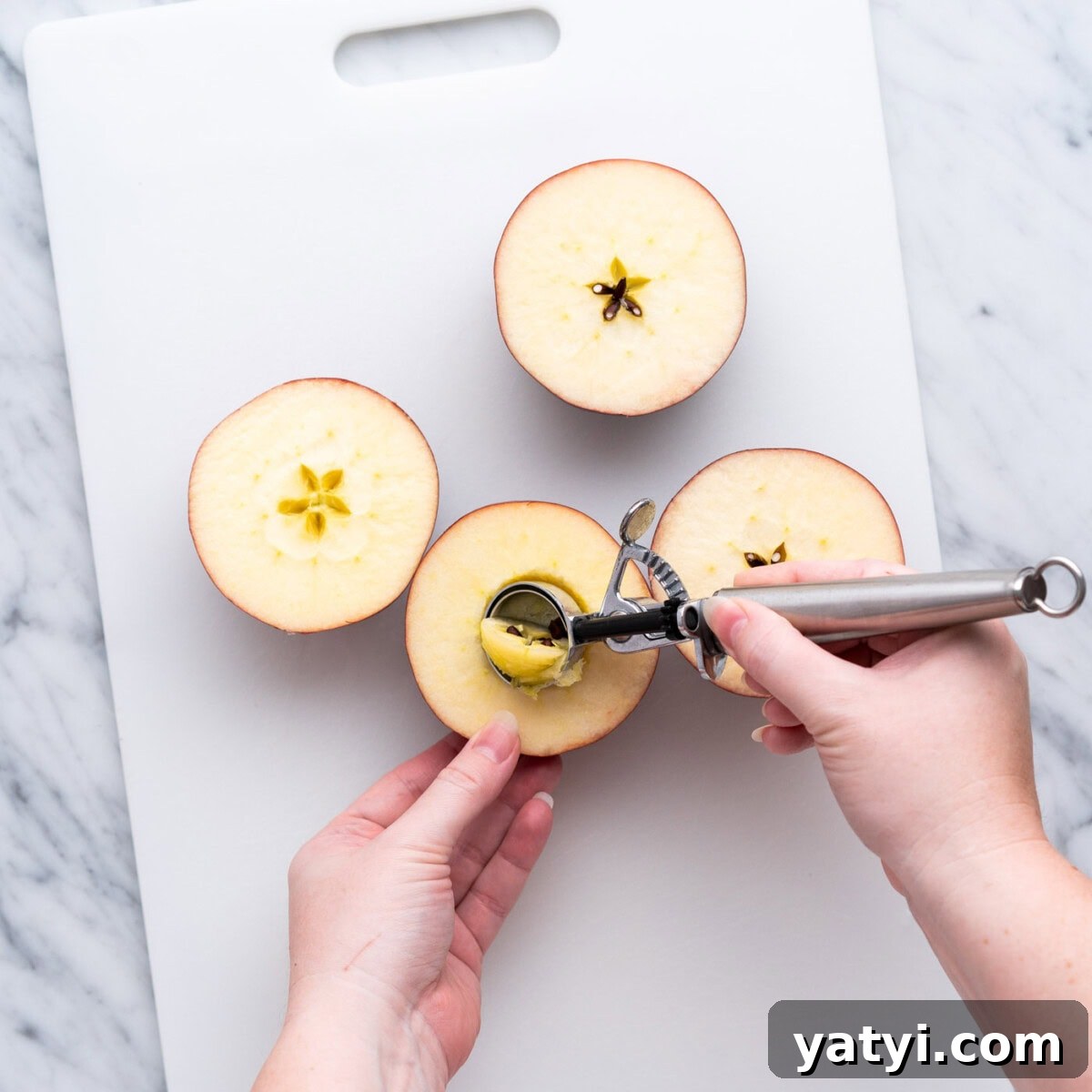 Cinnamon-Stuffed Baked Apples Made in the Air Fryer 5 coring apple halves on cutting board