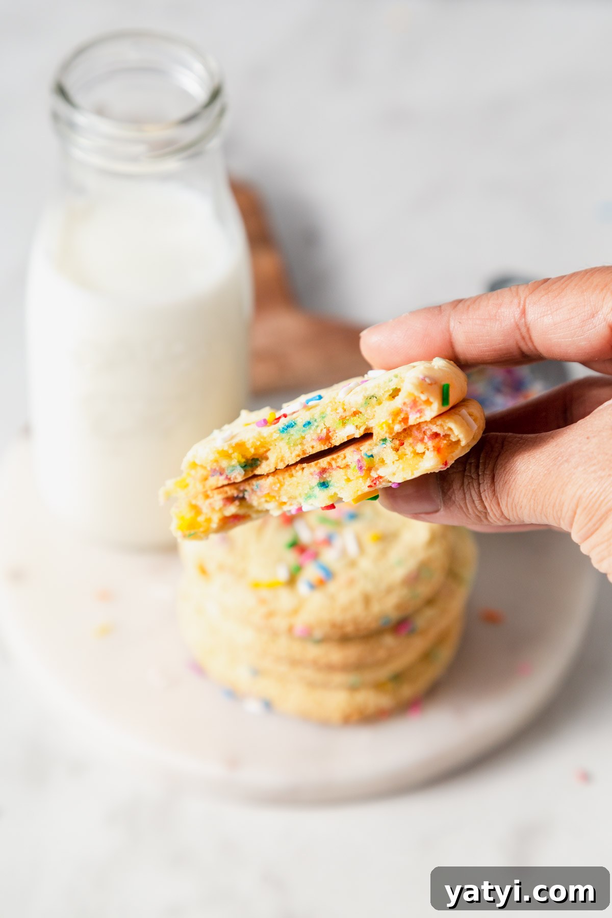 Chewy Yellow Cake Mix Cookies Recipe with Simple Ingredients 11 yellow cake mix cookies with sprinkles in halves.