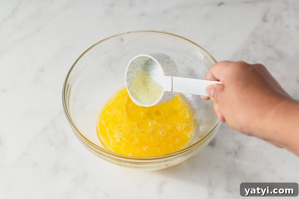 Chewy Yellow Cake Mix Cookies Recipe with Simple Ingredients 4 mixing eggs and oil for yellow cake mix cookies.