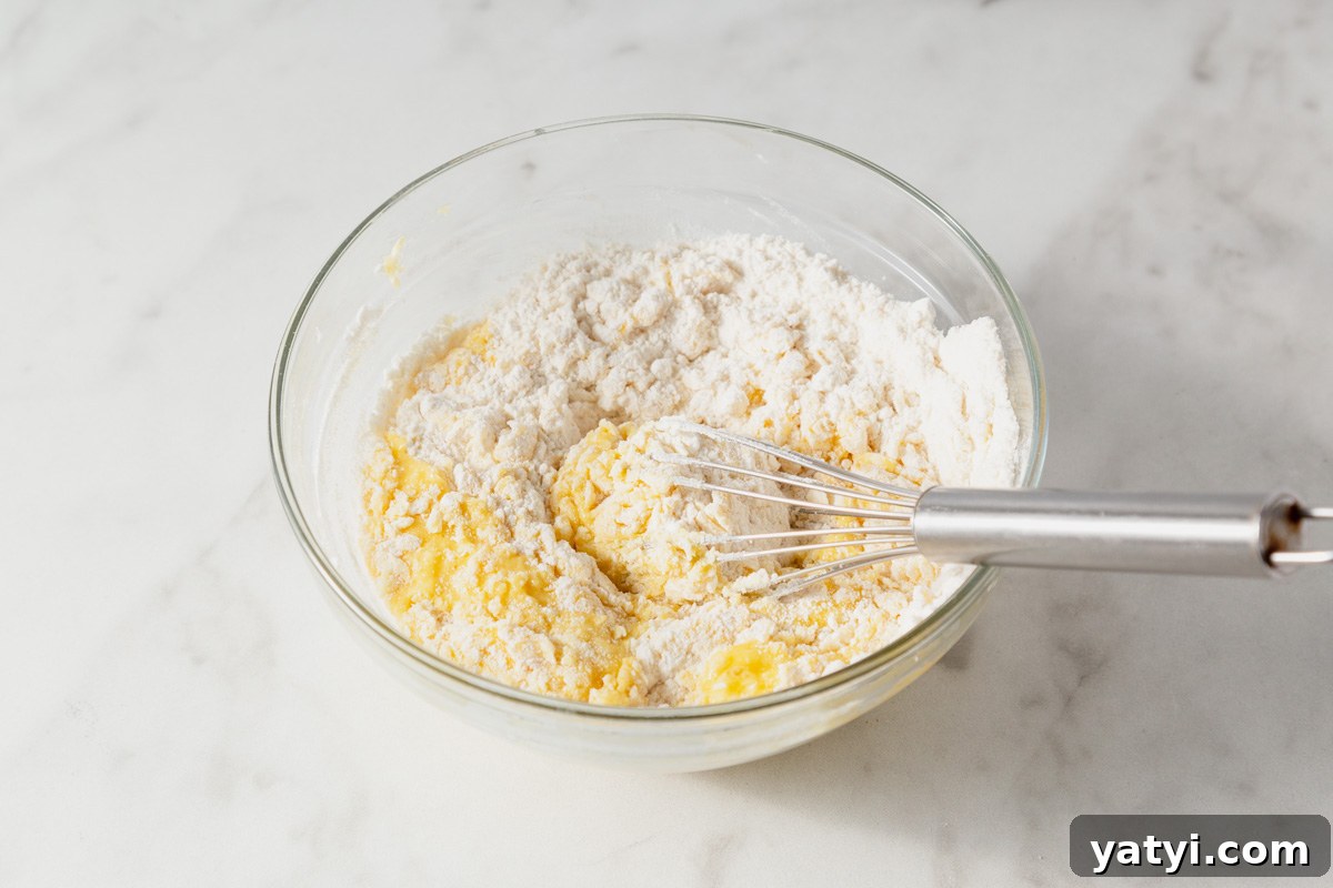 Chewy Yellow Cake Mix Cookies Recipe with Simple Ingredients 5 adding the cake mix to the wet ingredients.