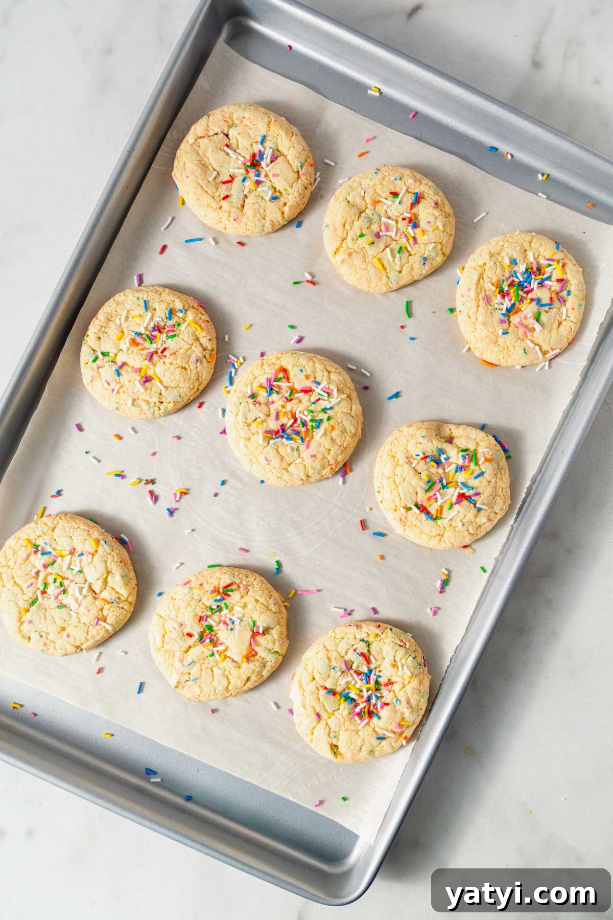 Chewy Yellow Cake Mix Cookies Recipe with Simple Ingredients 8 yellow cake mix cookies on the baking sheet.