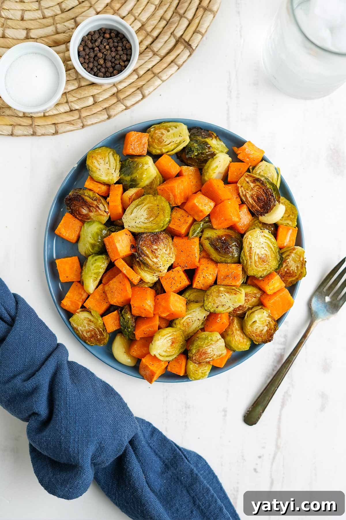 Crispy Roasted Brussels Sprouts with Maple-Roasted Sweet Potatoes 7 Overhead of bowl of brussel sprouts and sweet potatoes on the table.