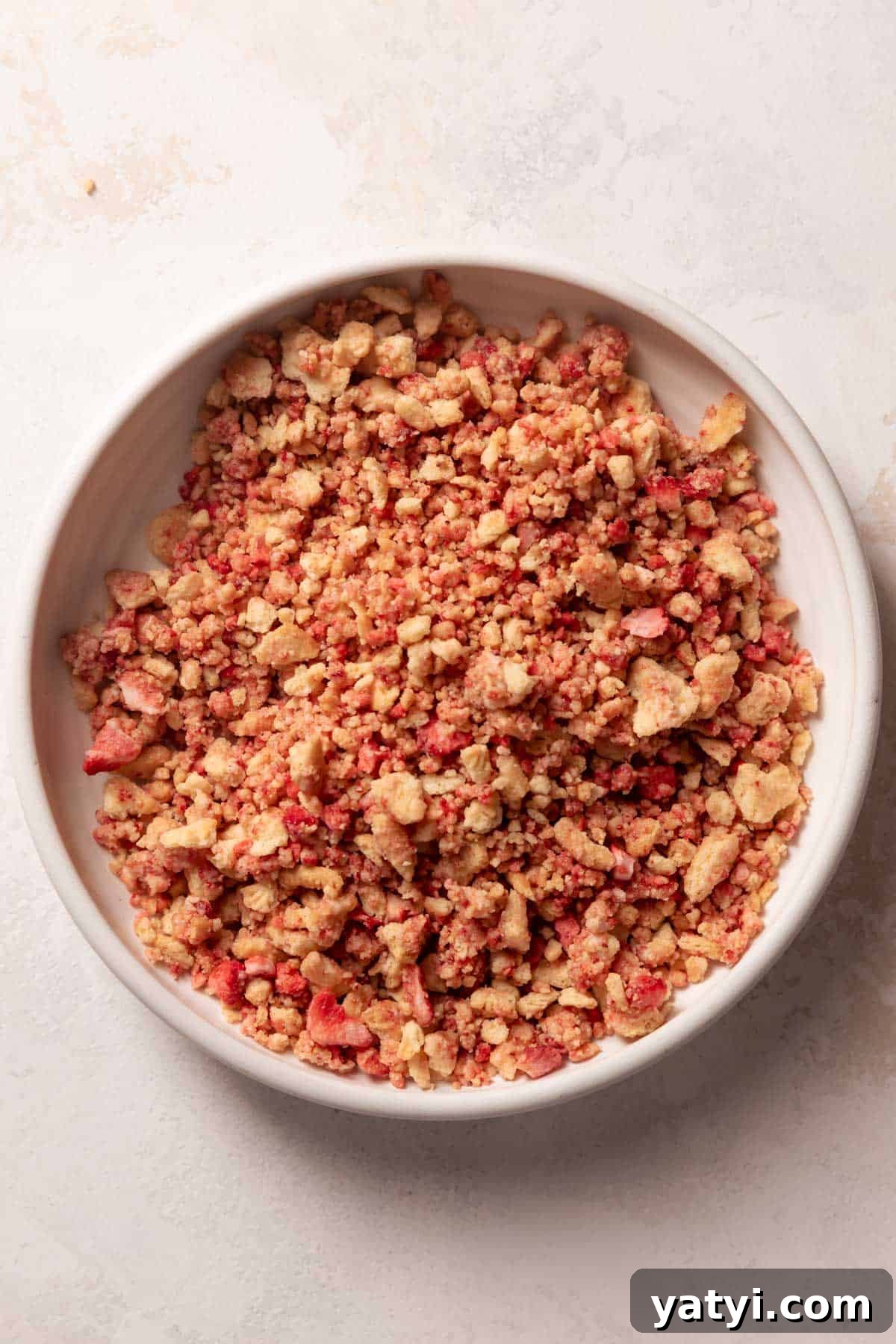 Strawberry Crunch Cupcakes Recipe with Crispy Topping 4 strawberry crunch topping in a white bowl.