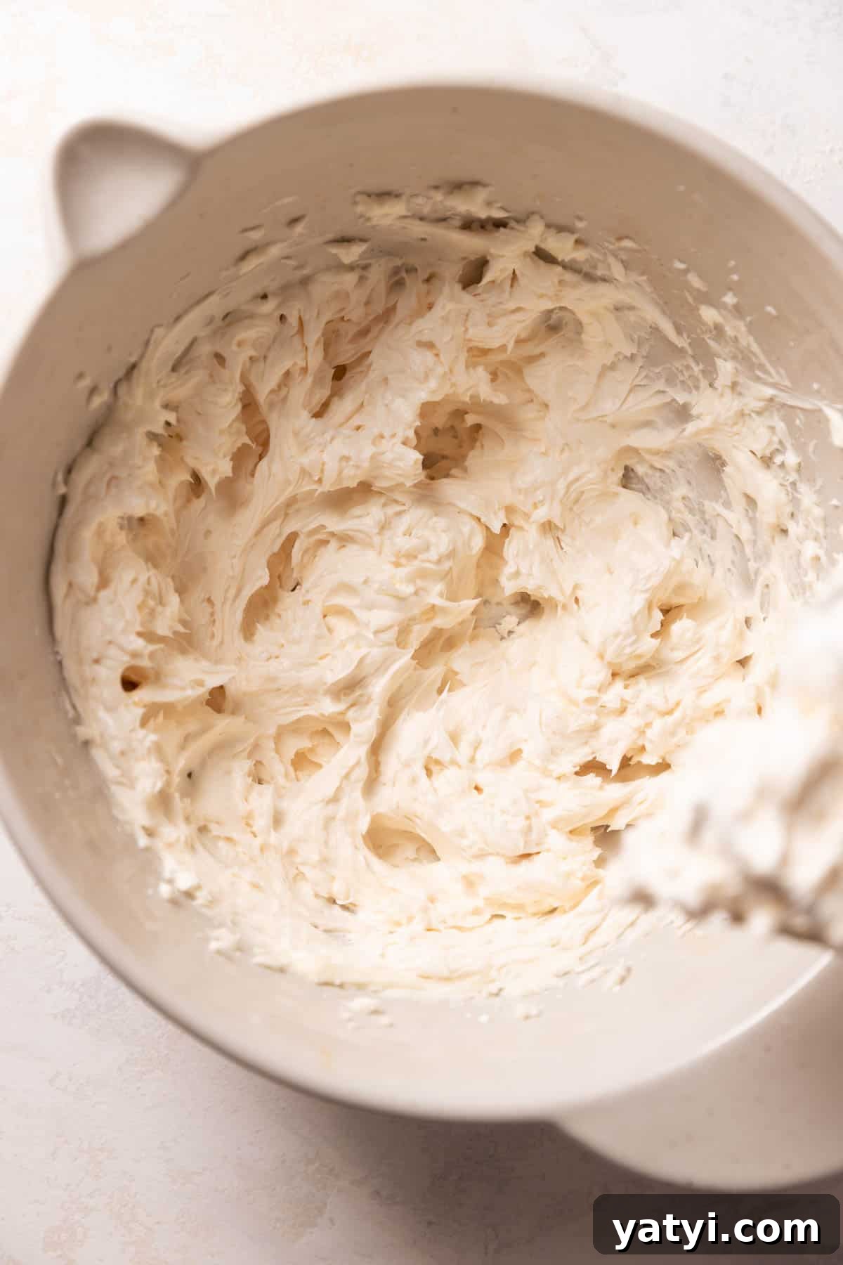 Strawberry Crunch Cupcakes Recipe with Crispy Topping 9 vanilla buttercream in a mixing bowl.