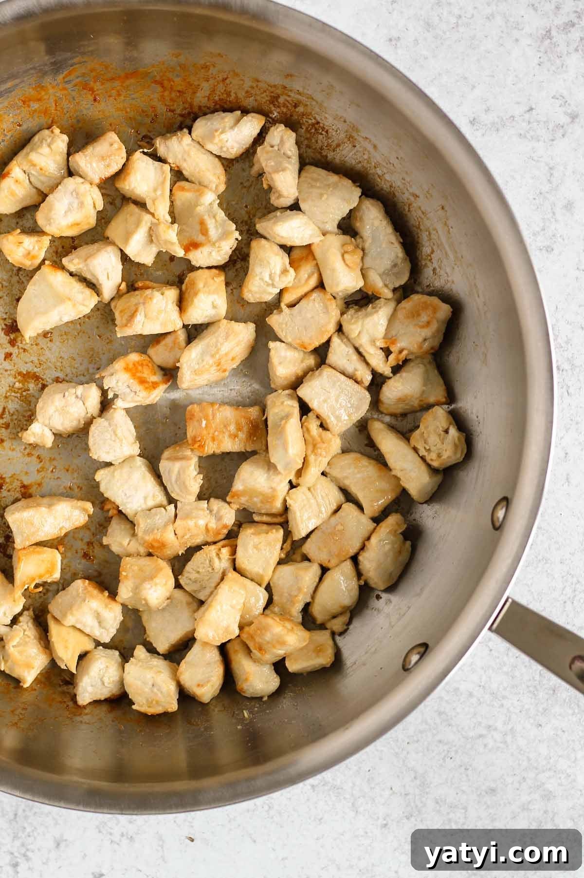Low-Sodium Fried Rice Without Soy Sauce — Flavorful Vegetable Fried Rice 4 Cooked chicken pieces in a large cast iron skillet.