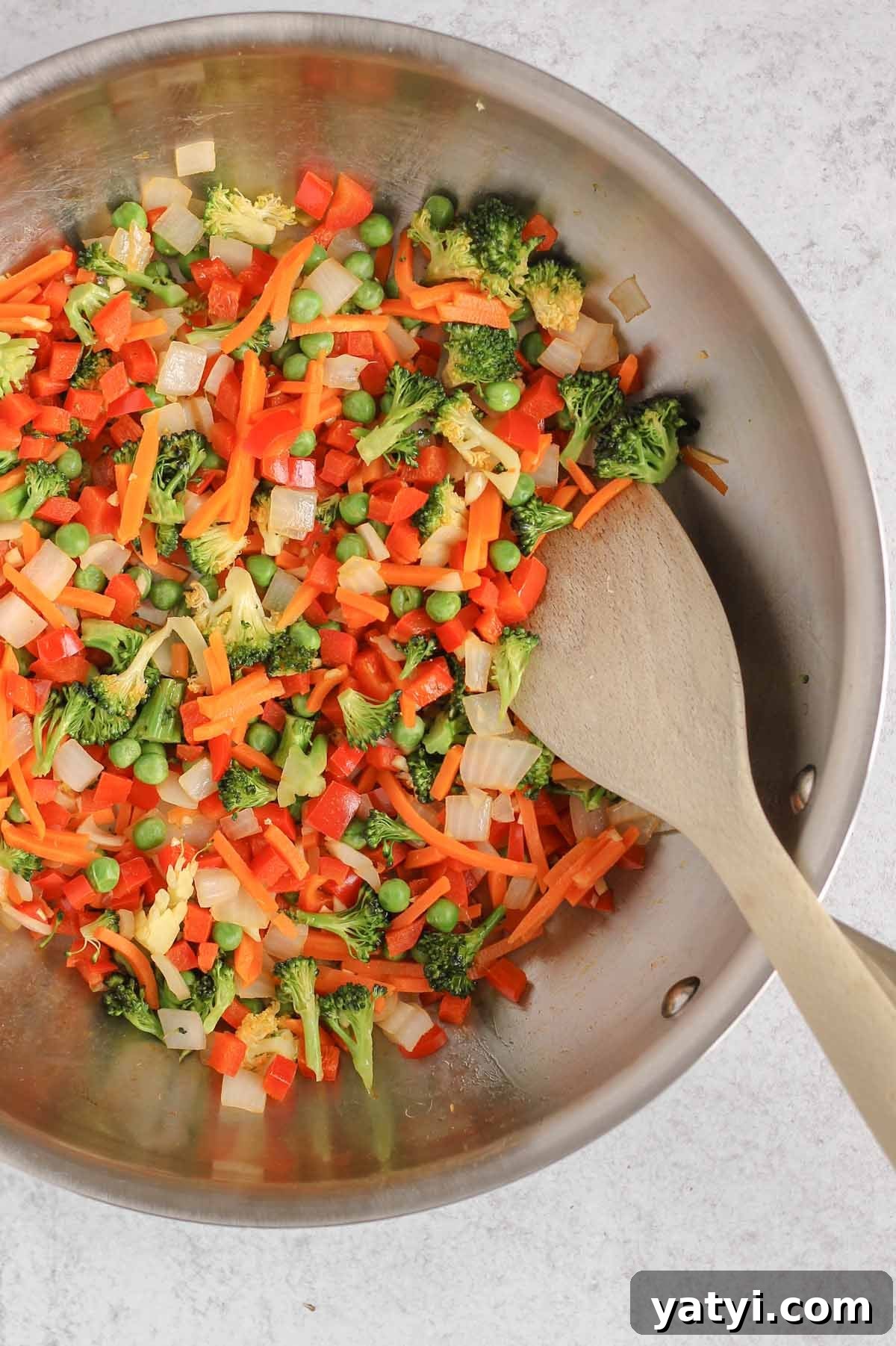 Low-Sodium Fried Rice Without Soy Sauce — Flavorful Vegetable Fried Rice 5 Sautéed veggies for fried rice in a large cast iron skillet.