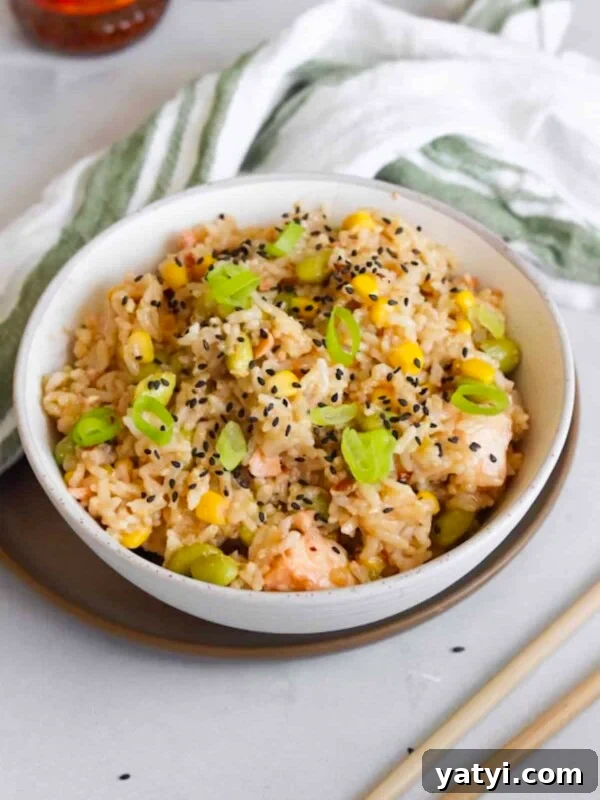 Slow Cooker Thai Red Curry with Chicken and Coconut Milk 12 One pot salmon rice bowl made in the rice cooker plated in a white bowl and topped with sesame seeds