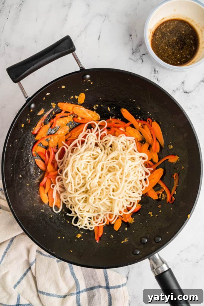 Garlic Shrimp Lo Mein Recipe — Quick Stir-Fry Noodles 11 Cooked lo mein noodles added to the wok with the sautéed vegetables.