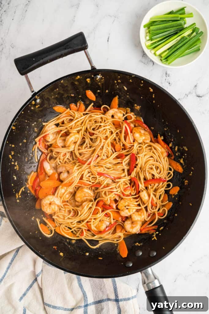 Garlic Shrimp Lo Mein Recipe — Quick Stir-Fry Noodles 13 Shrimp, noodles, carrots, and bell peppers tossed together in a wok with sauce.