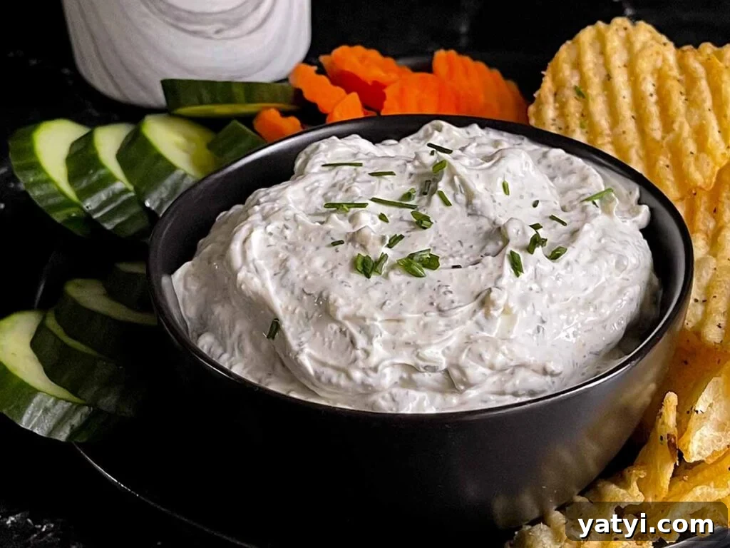Fresh Herb Veggie Dip Recipe for Parties and Snacks 6 Chip dip in a black bowl surrounded by chips and vegetables