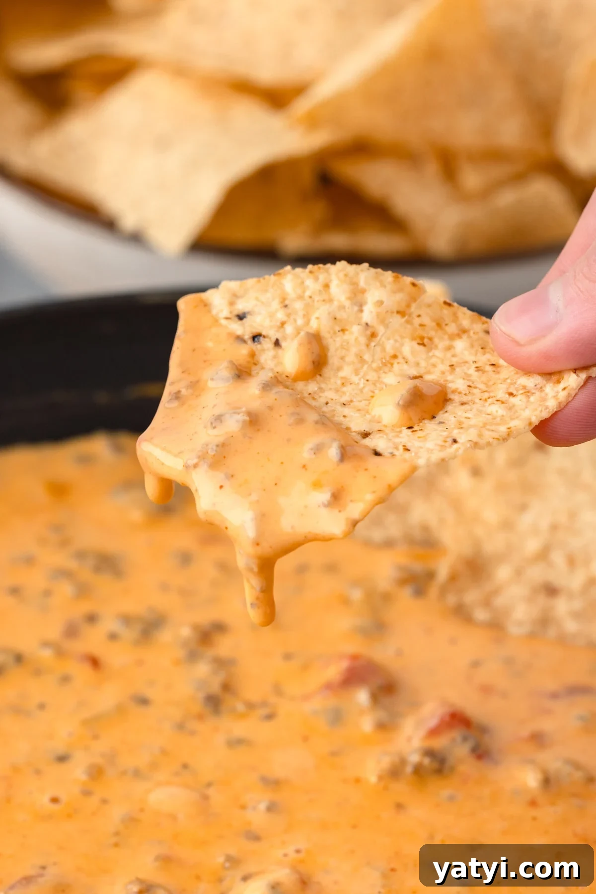 Creamy Velveeta Sausage Dip Recipe for Parties and Game Day 2 up close photo of a creamy cheese drip on a tortilla chip