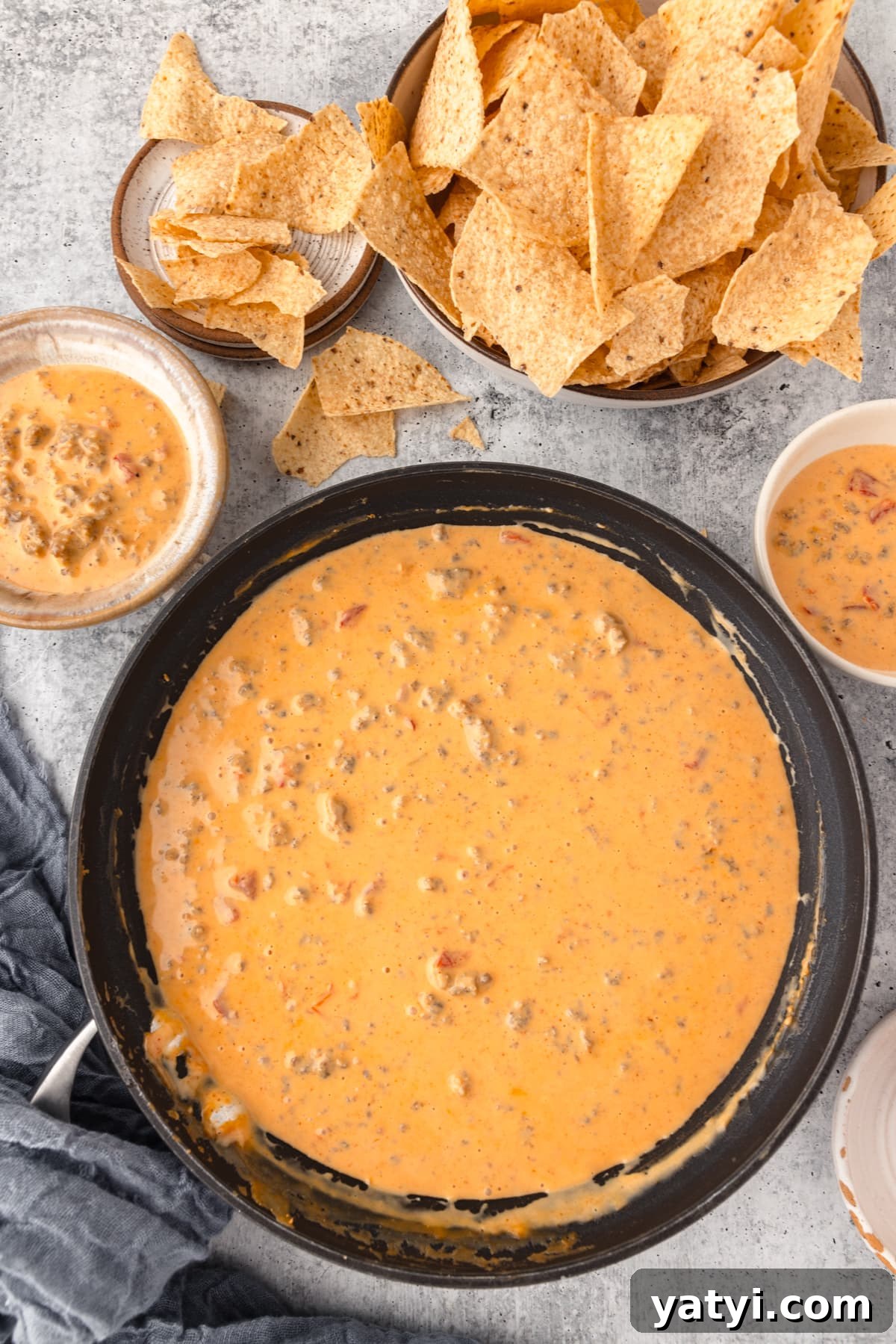 Creamy Velveeta Sausage Dip Recipe for Parties and Game Day 3 a Skillet full of melted cheese served alongside tortilla chips