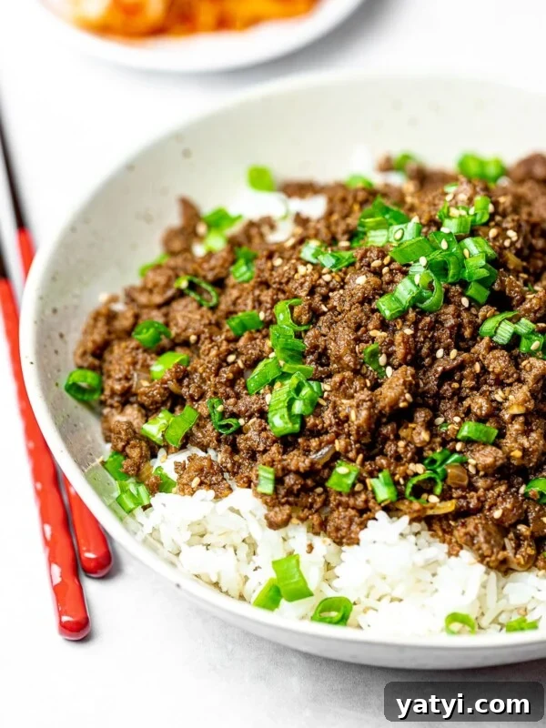 Korean beef bowl with rice and red chopsticks; bulgogi bowl