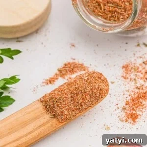 How to Use Cajun Seasoning: Flavor Tips, Recipes & Pairings 15 Cajun seasoning on a small wooden spoon and in a jar.