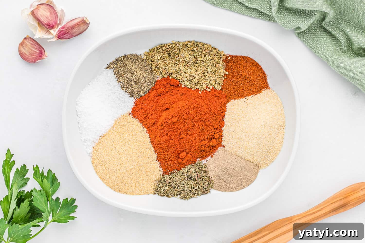 How to Use Cajun Seasoning: Flavor Tips, Recipes & Pairings 6 Unmixed spices in a white bowl.