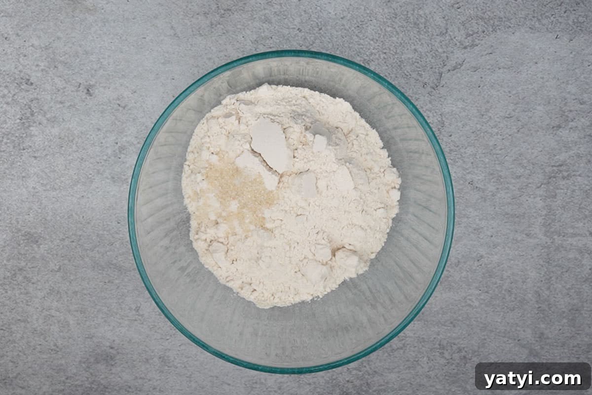Whole wheat flour, salt, sugar and semolina added to a bowl.