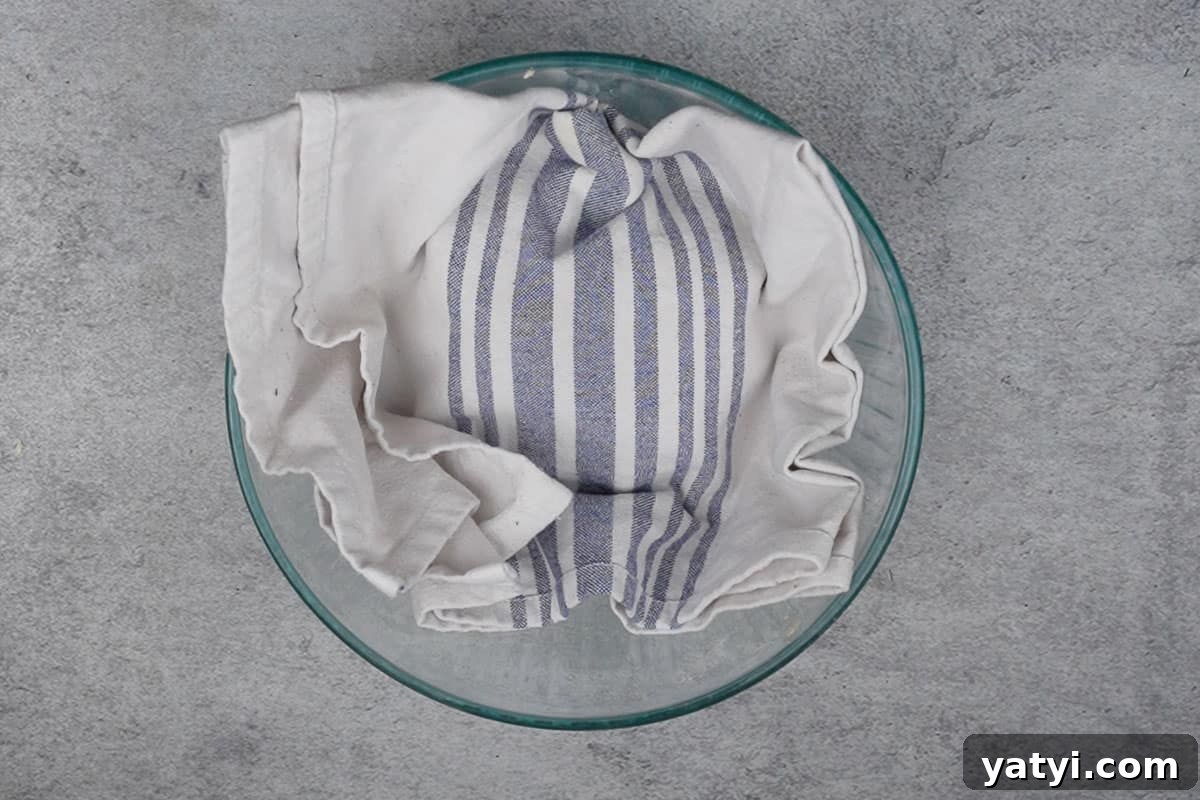 Dough covered with a kitchen cloth.