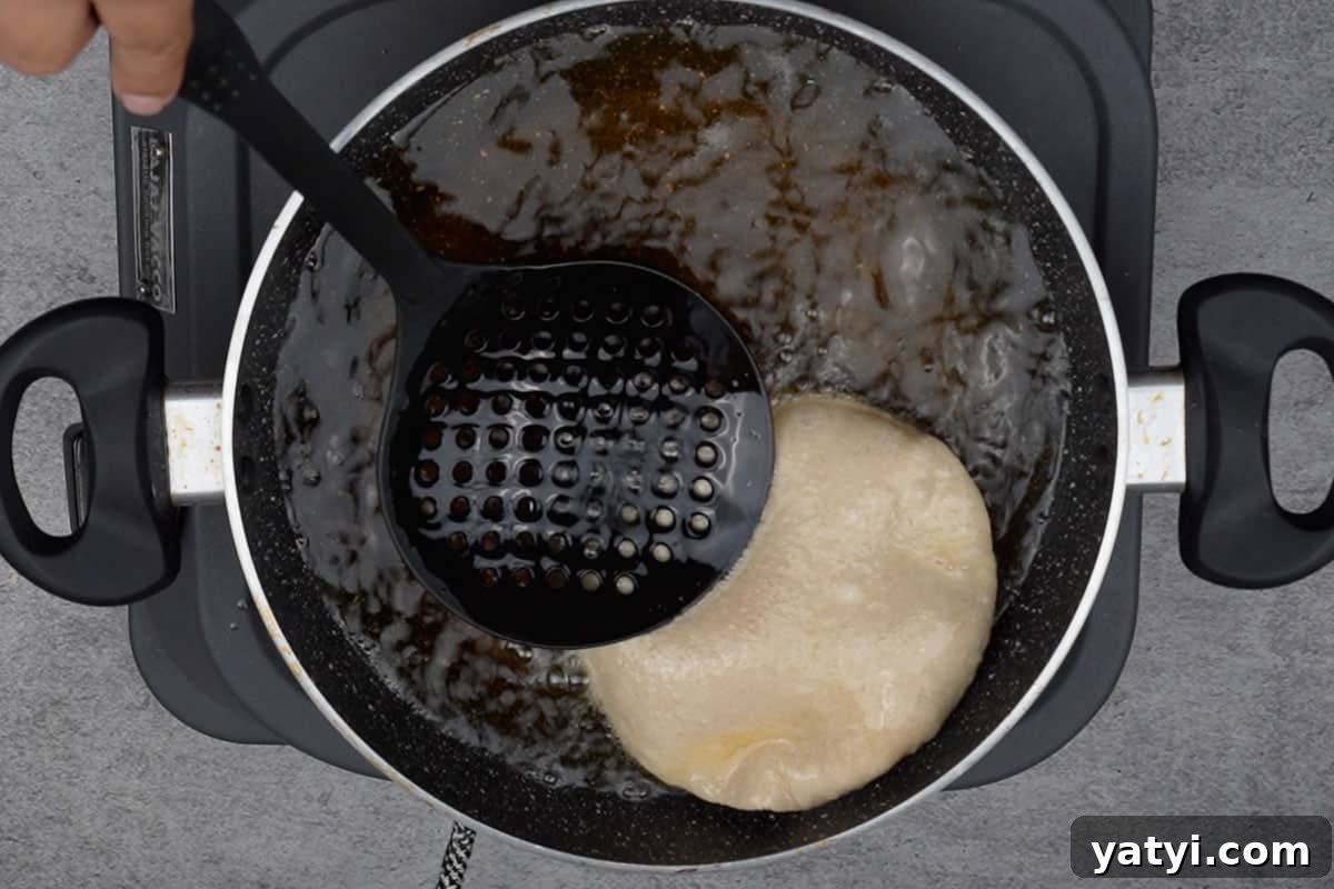 Poori frying in hot oil.