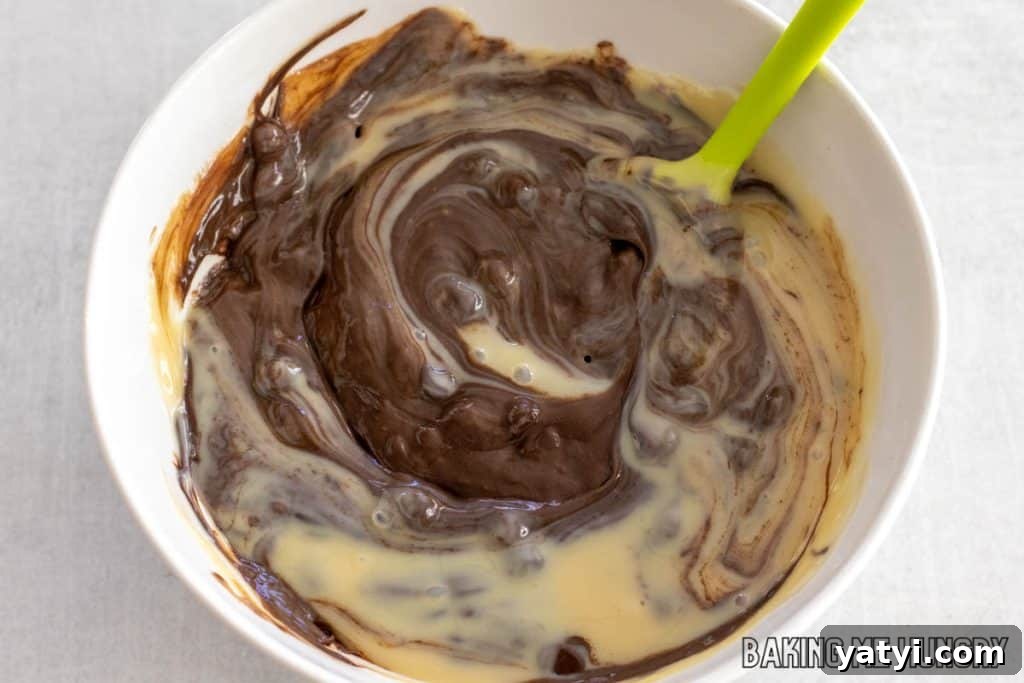 3-Ingredient Microwave Fudge Recipe: Quick Chocolate Fudge 5 condensed milk and chocolate chips being stirred
